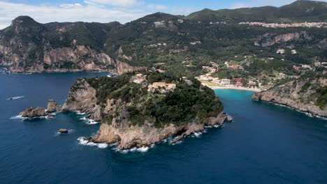 Zooming-out-shot-of-coastal-headland-in-greece-with-monastery-on-top