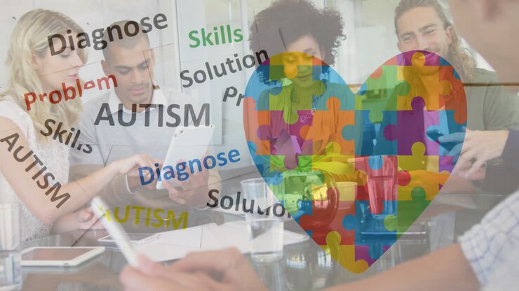 Animation of colourful puzzle pieces, autism text over business colleagues with electronic devices