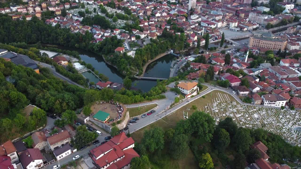 Aerial view with pan down onto Yellow Fortress and Milijacka River at sunset in Sarajevo, Bosnia and Herzegovina