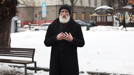 a sick elderly man clutches his chest, he has heart problems.