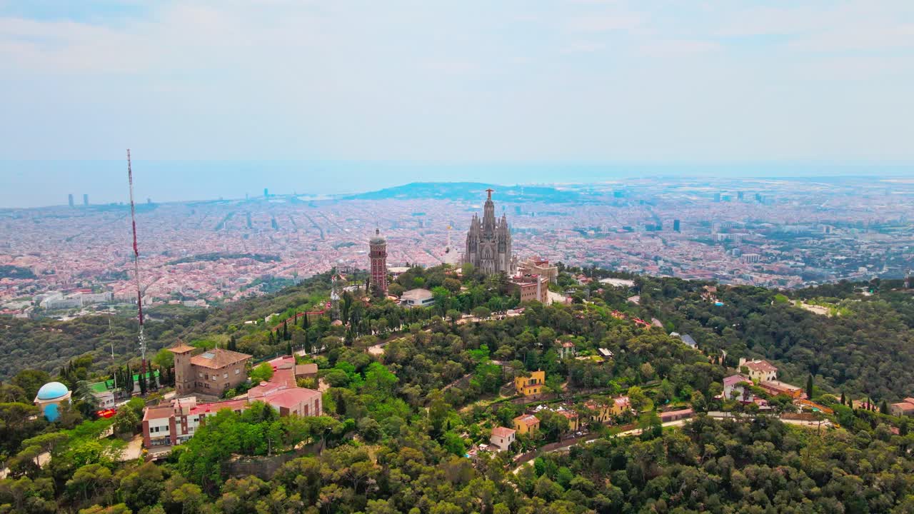 Aerial drone 4K footage of Tibidabo in Barcelona, showcasing the majestic mountain, iconic amusement park, and panoramic views