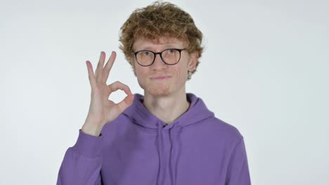 ok sign by redhead young man, white background