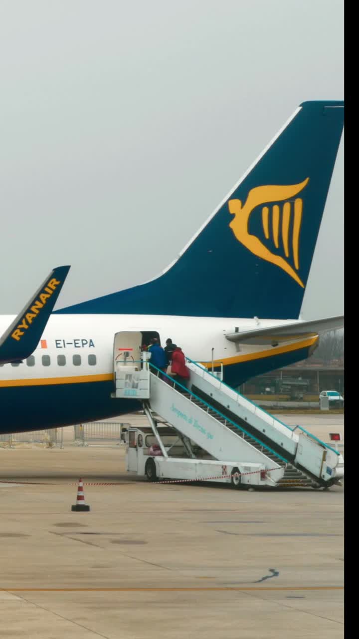 Ryanair airplane at airport with people boarding