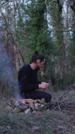 Man Making Campfire in the Woods
