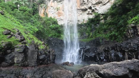 a serene waterfall amidst dense greenery