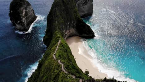 4k drone shot of kelingking beach in nusa penida, bali, indonesia. t-rex shaped land.