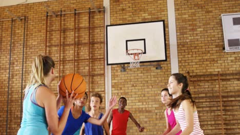 high school kids playing basketball in the court