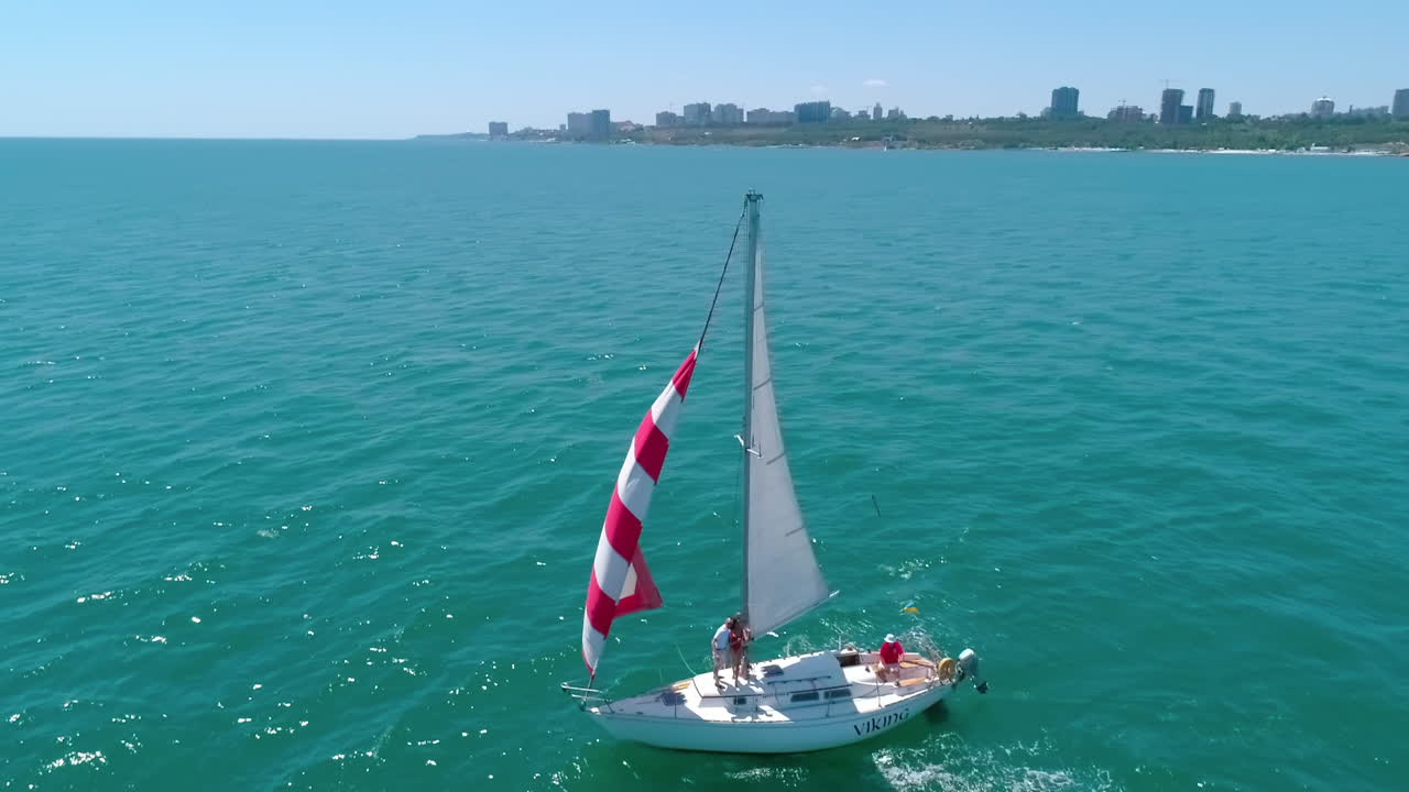 Luxury ship at open sea. Seascape with sails yacht in open sea, aerial view