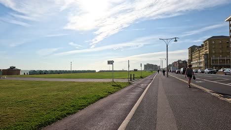 people walking along a seaside footpath