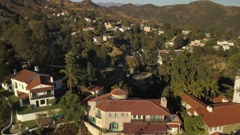 Aerial-shot-of-LA-blue-sky-and-mountains-in-background-city-desert-trees-water-city-in-background