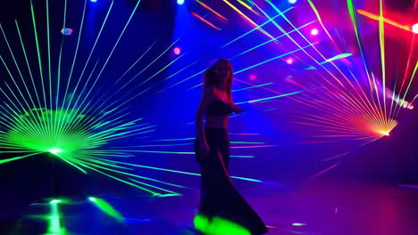 woman dancing amidst vibrant laser lights