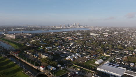 wide aerial flying over a neighborhood outside of downtown new orleans in the morning