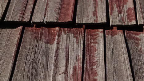 weathered wooden shingles texture with faded red paint