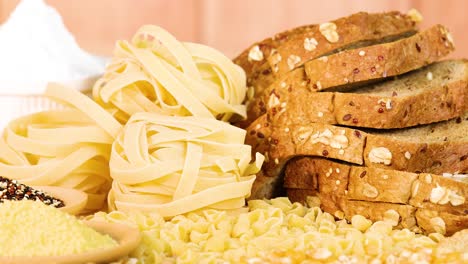 a variety of grains and breads displayed with warm lighting, highlighting textures and colors in a close-up composition