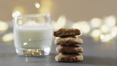 video of christma cookies, glass of miljk and copy space on grey background