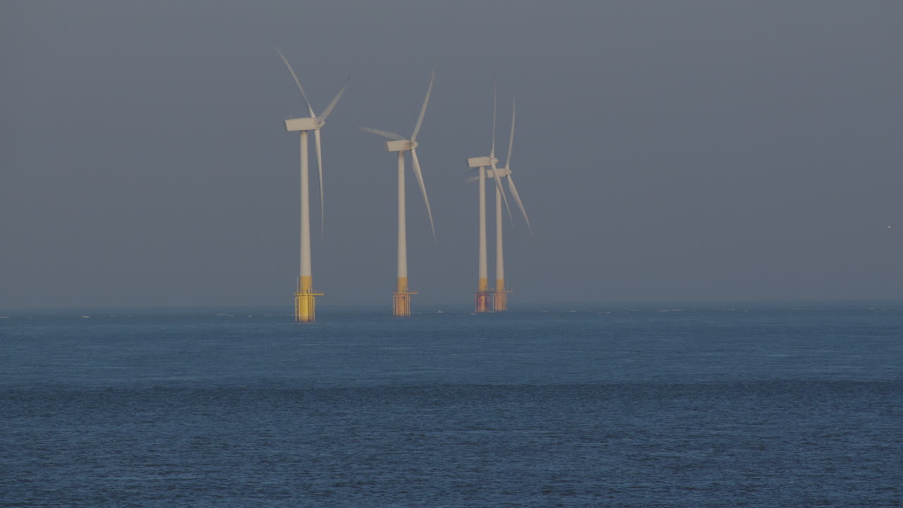 Long shot of 3 Offshore wind turbines at Scroby Sands Wind Farm