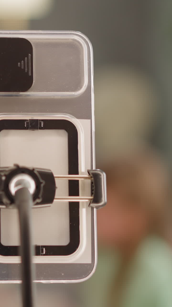 madre con hija huevos de color para la celebración de pascua en la sala de estar vista borrosa cámara lenta. centrarse en el teléfono inteligente y anillo de luz. disparar vlog familiar