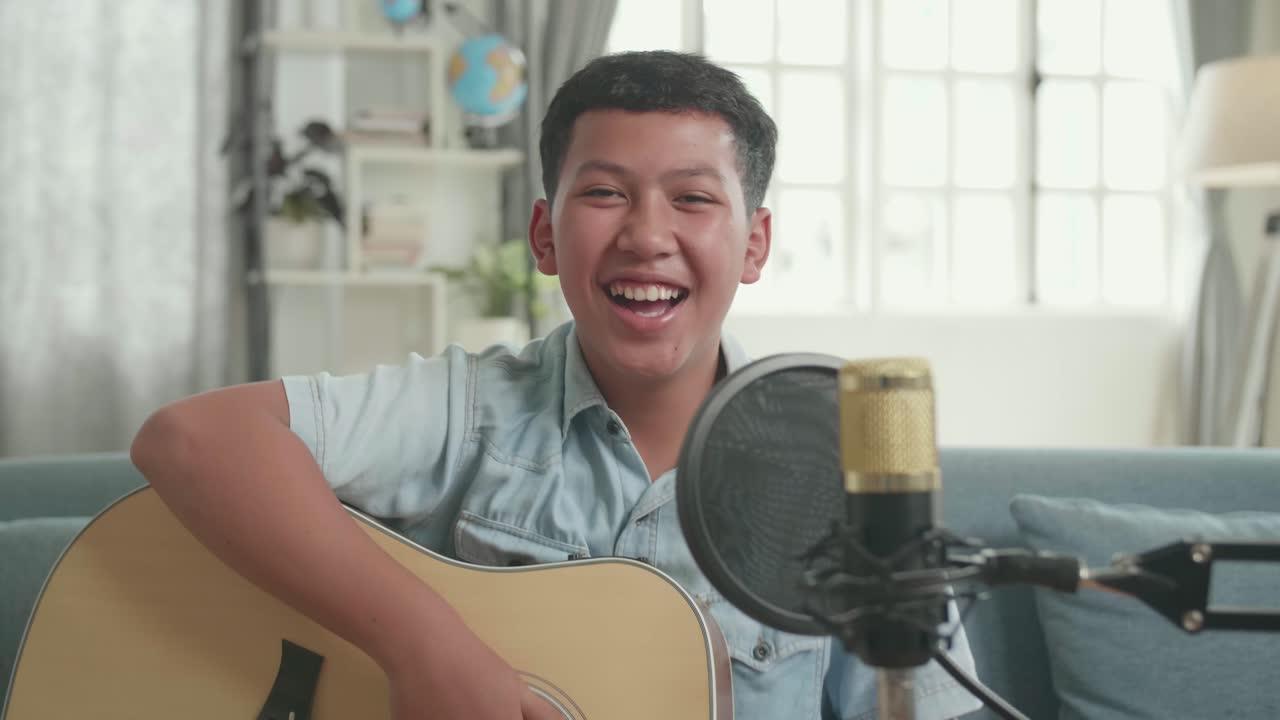 Teenager Singing and Playing Guitar
