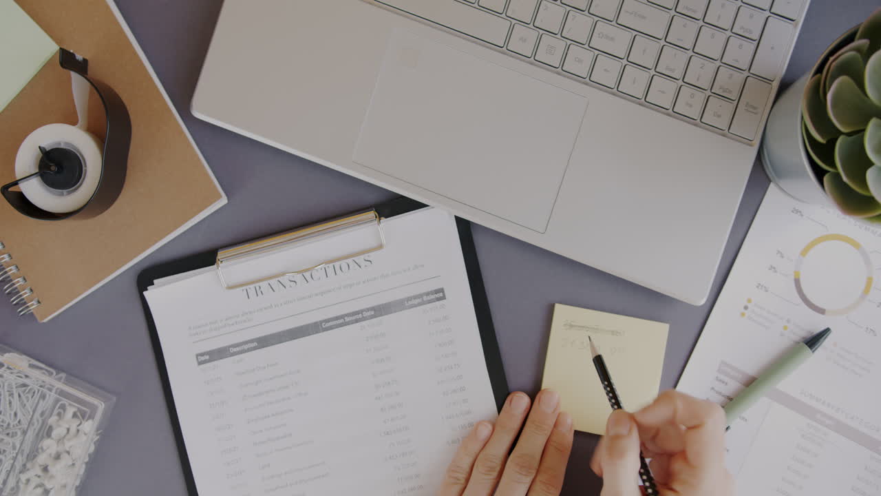 Person reviewing financial documents at a desk