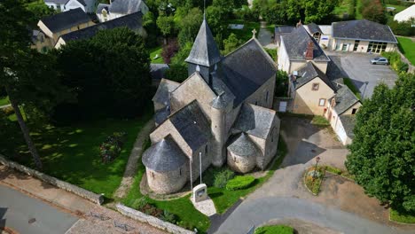 Saint-Sulpice Church, neighborhood Grenoux, Laval in France. Aerial drone top-down orbiting