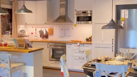 a modern kitchen corner featuring a sleek oven, rangehood, and organized countertop with decor.