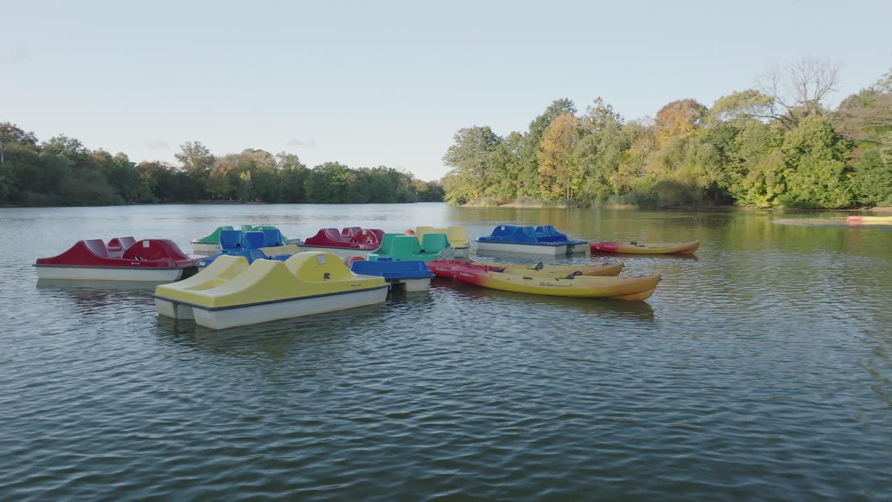 Colorful Pedal Boats and Kayaks on a Calm Lake