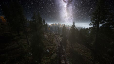 the milky way above the railway and forest