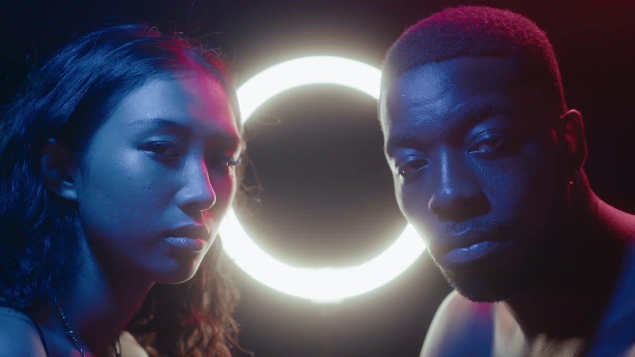Neon Portrait of Young Man and Woman against Ring Light