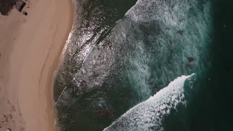 High-Aerial-Drone-Fly-Over-Footage-of-deep-green-emerald-ocean-beach-with-rushing-waves-at-Cabo-San-Lucas,-Mexico