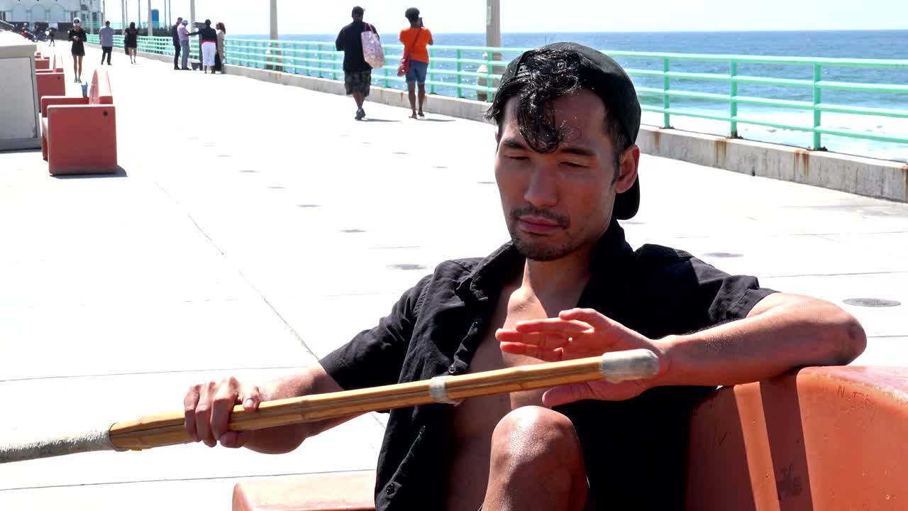 Carefree Asian man enjoying the pier