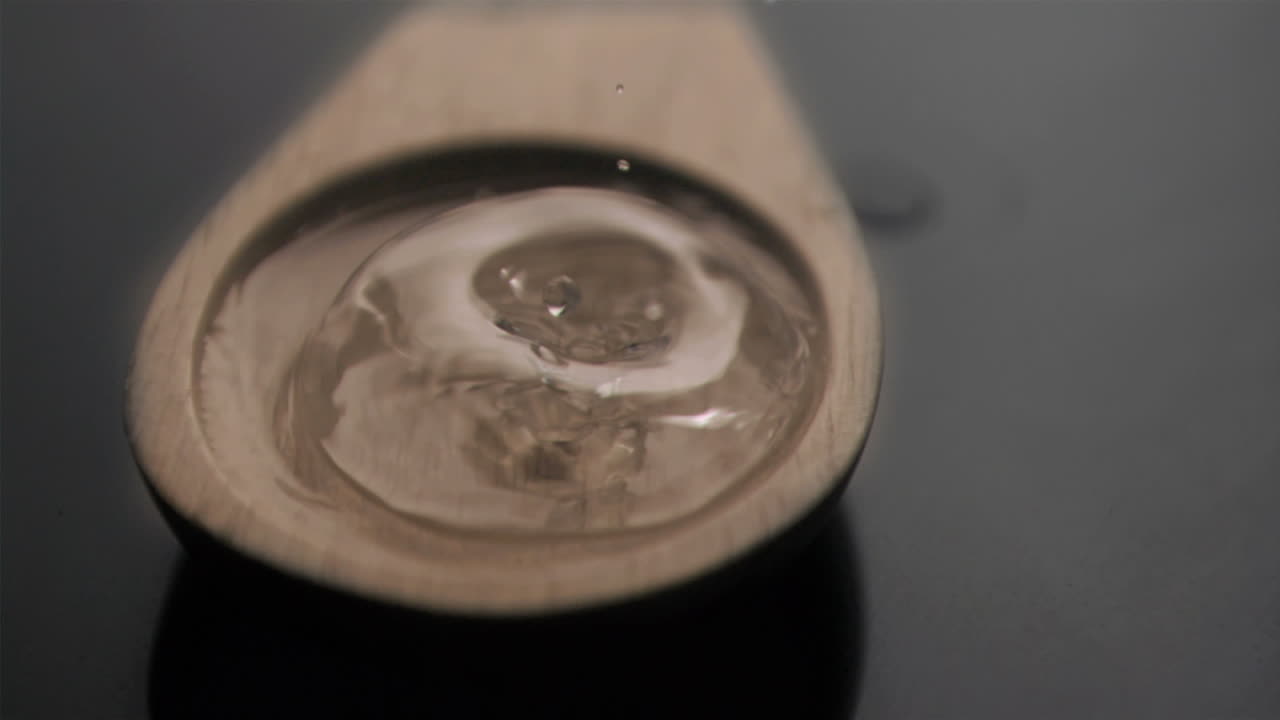 Bubble popping in super slow motion in a wooden spoon