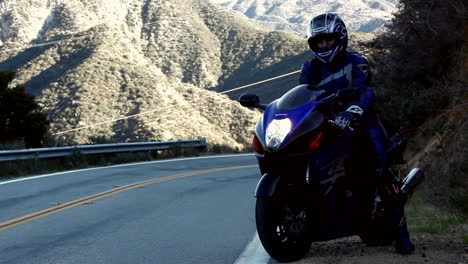 Motorcyclist-pulls-out-onto-a-winding-mountain-road