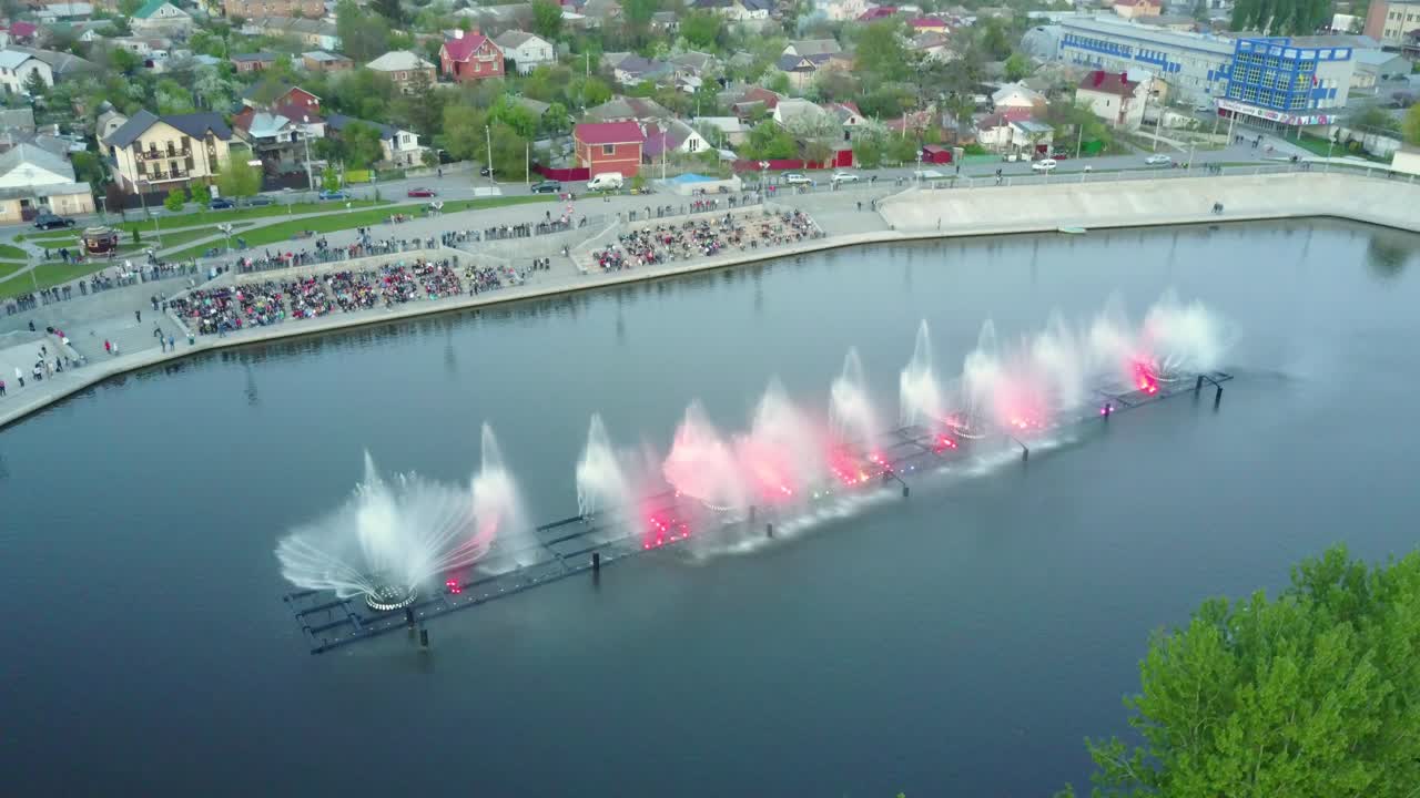 Musical Fountain Show. Aerial shot of the beautiful fountain show with reflection on water