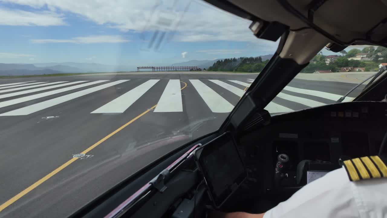 A pilot’s view from inside a jet cockpit exiting the airport runway after landing