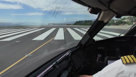 a pilot’s view from inside a jet cockpit exiting the airport runway after landing