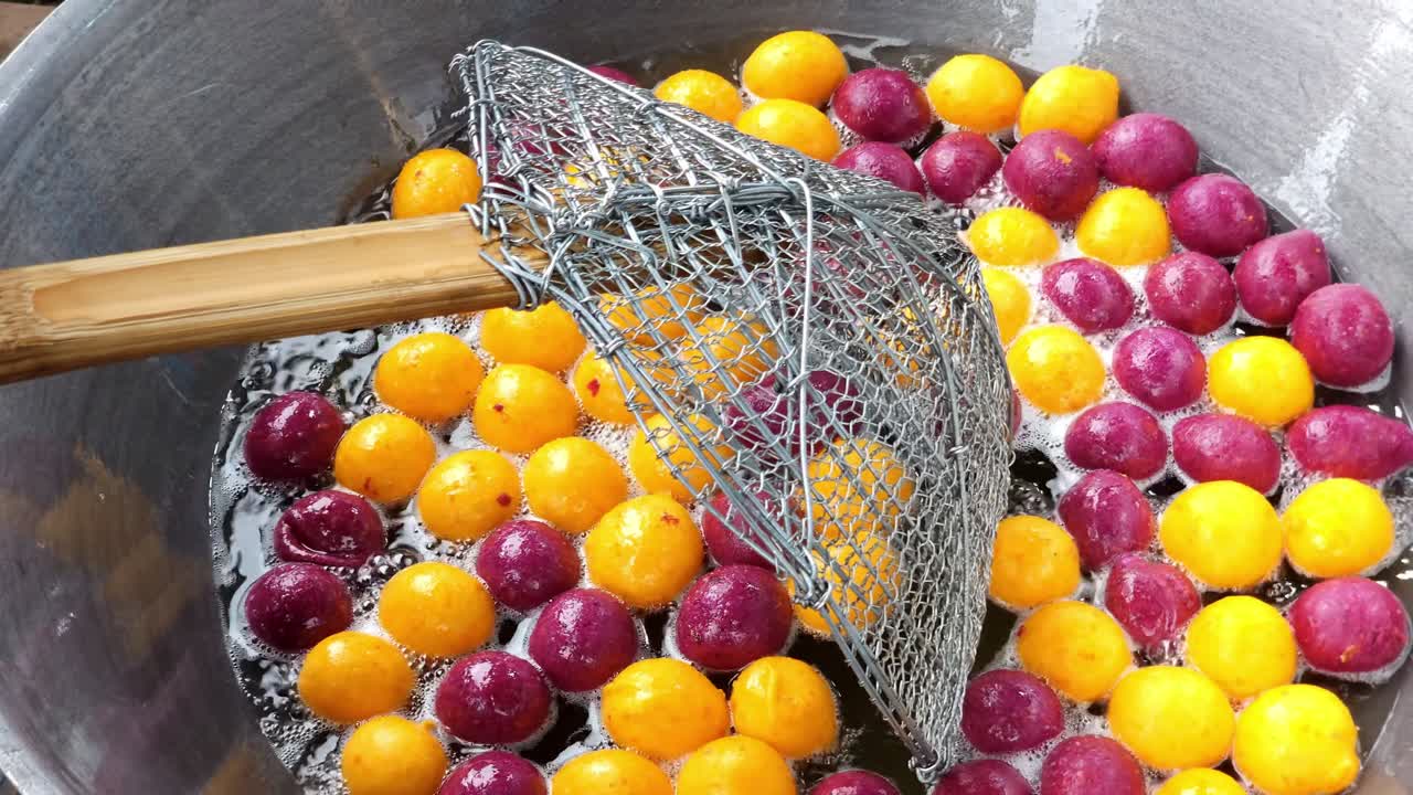 Watch as colorful eggs are mixed a bustling local market showcasing culinary traditions.