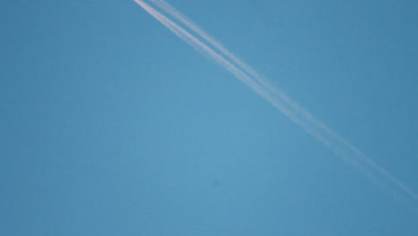 plane crossing a blue sky