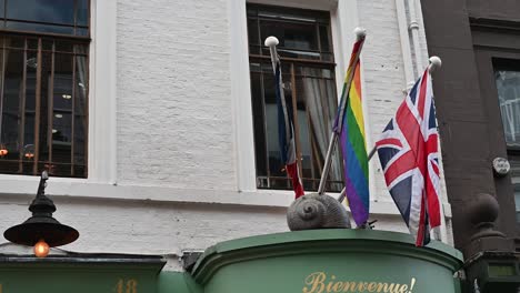 flags above l'escargot restaurant, london, united kingdom