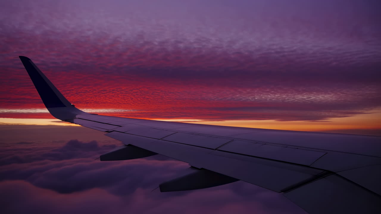 Airplane Wing View During Vibrant Sunset Flight