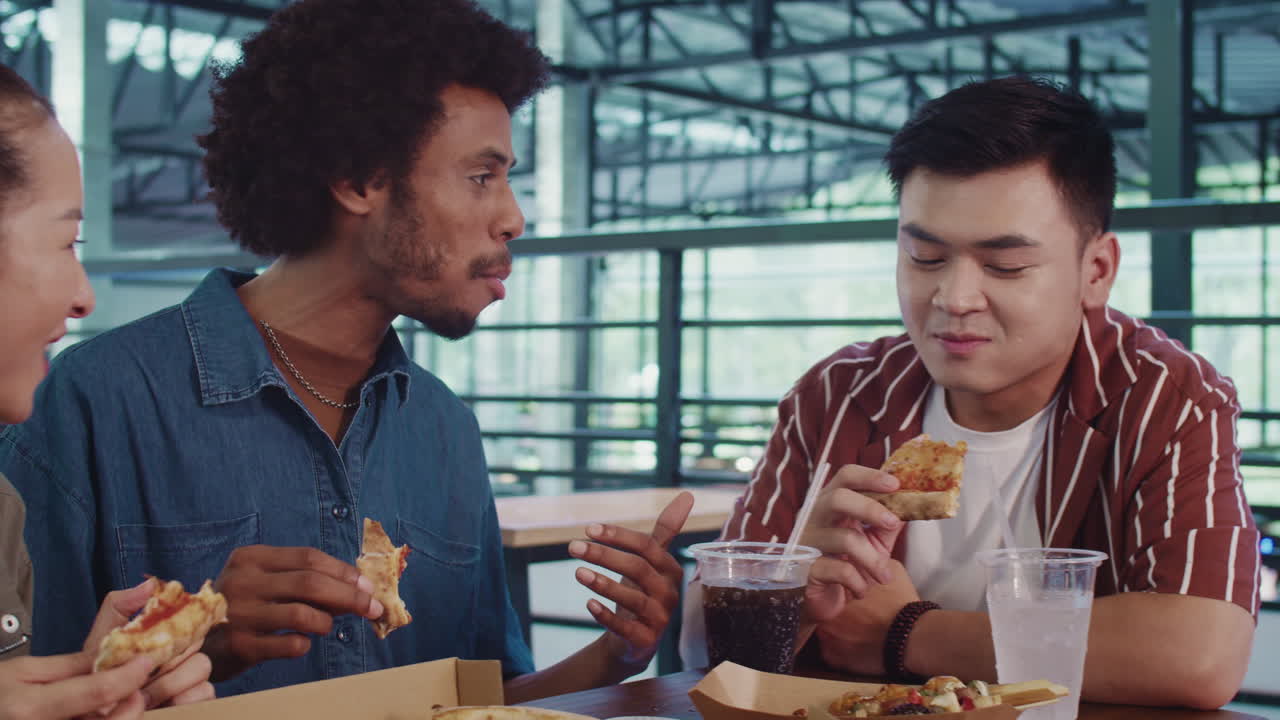 Diverse Positive Couple Having Lunch in Cafe with Friend