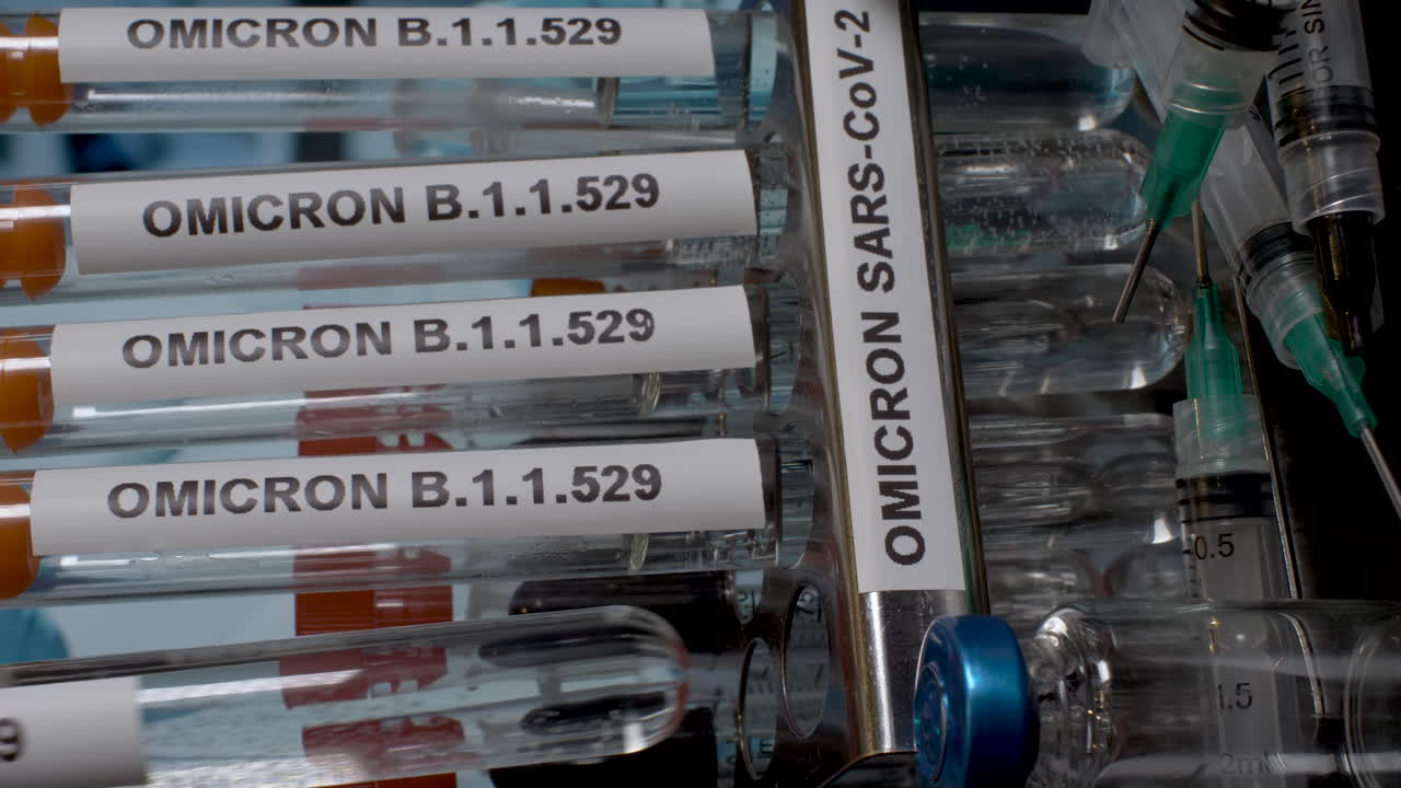 A close up vertical video of sealed test tube samples of Omicorn B.1.1.529 being placed into a laboratory rack, the new strain of the pandemic raising health care concerns globally
