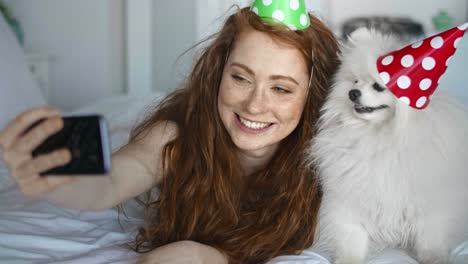 handheld video of woman taking birthday selfie with her dog