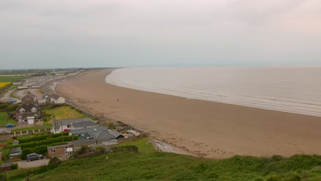 Coastal-view-of-Somerset,-England-from-Brean-Down-promontory,-showing-beach,-sea,-and-houses