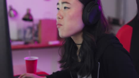 asian, woman and gamer at computer eating