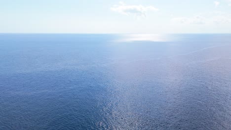 light blue sky and horizon above current ripples of ocean water in caribbean