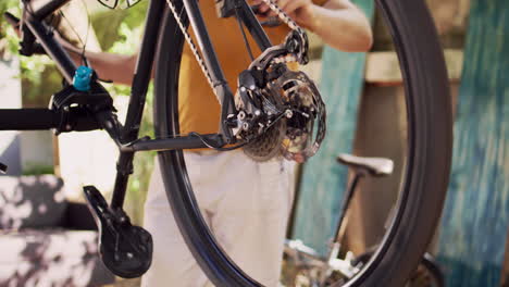 man thoroughly inspecting bicycle tire