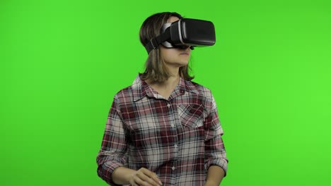 girl using vr app helmet to play simulation scary game. woman watching virtual reality 3d video