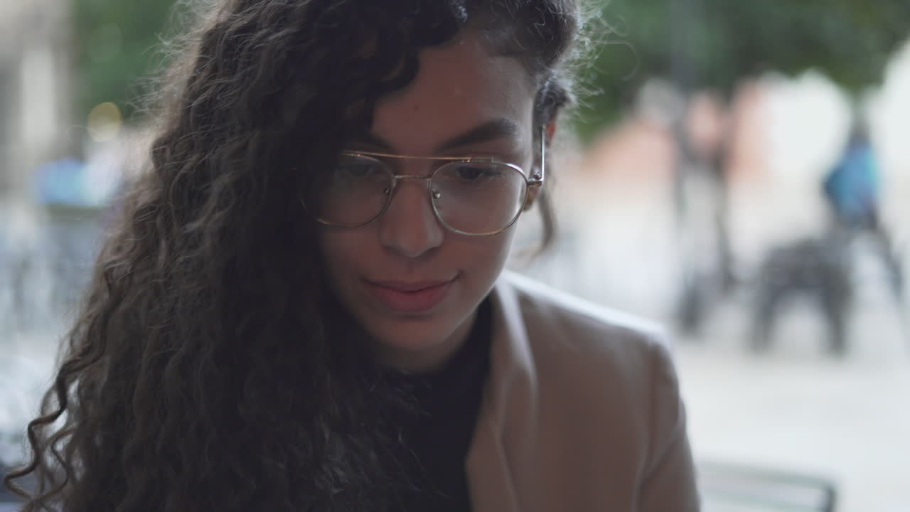 Young Woman with Curly Hair and Glasses