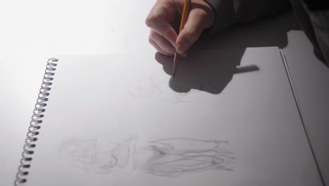 girl drawing sketch anatomy woman body using a pencil in her studio