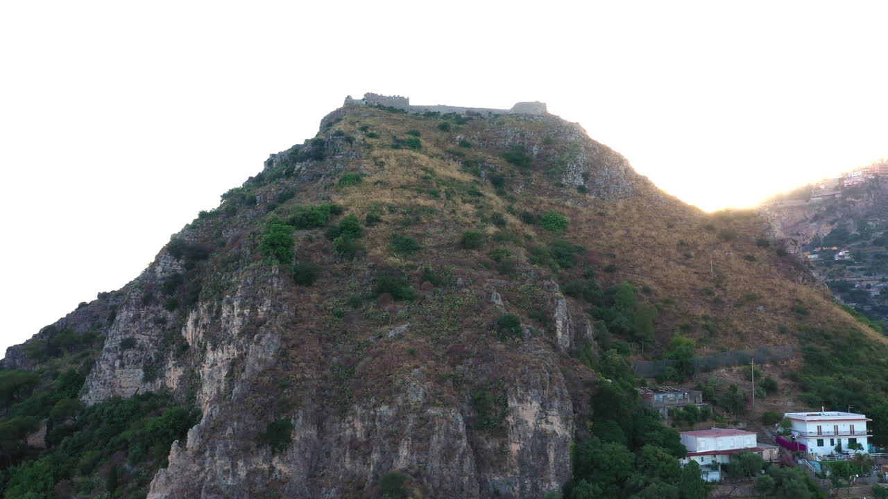 toma aérea de seguimiento de la montaña delineada con sol de color dorado
